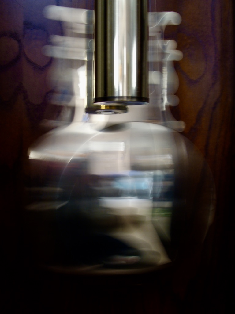 Photo is of a moving pendulum and weight inside a grandfather clock