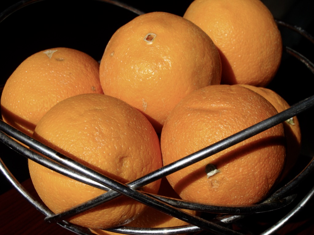 Wire basket full of oranges