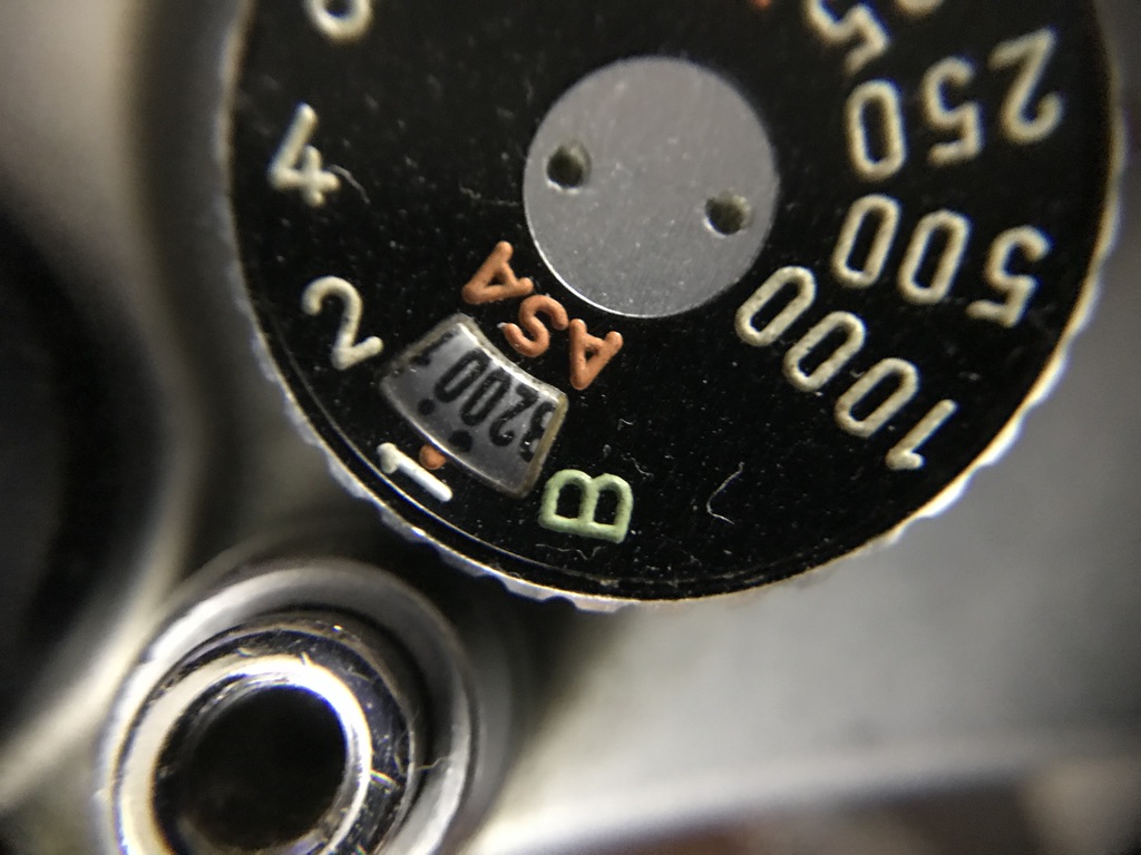 Close up photograph of the ASA setting on a manual film camera