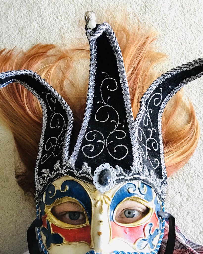 Person wearing a Mardi Gras mask