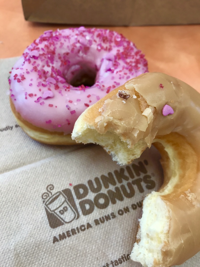 2 donuts resting on a Dunkin' Donuts napkin
