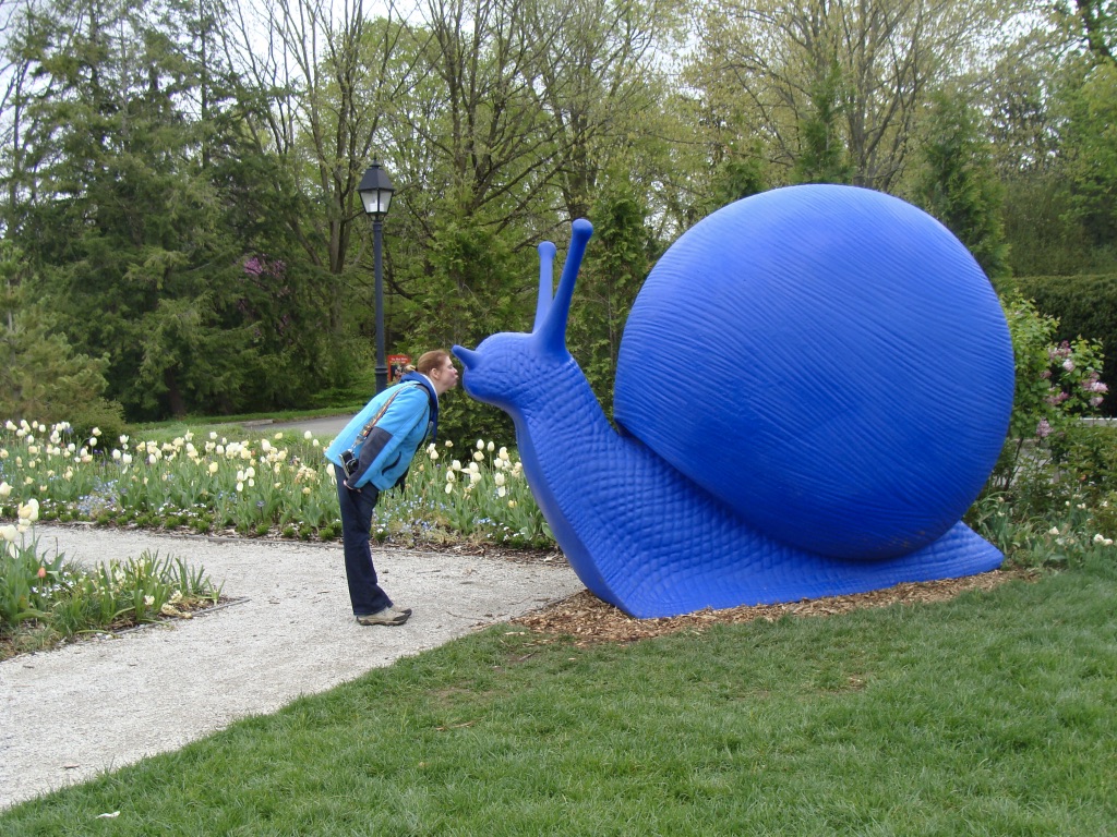 Girl kissing a giant blue snail