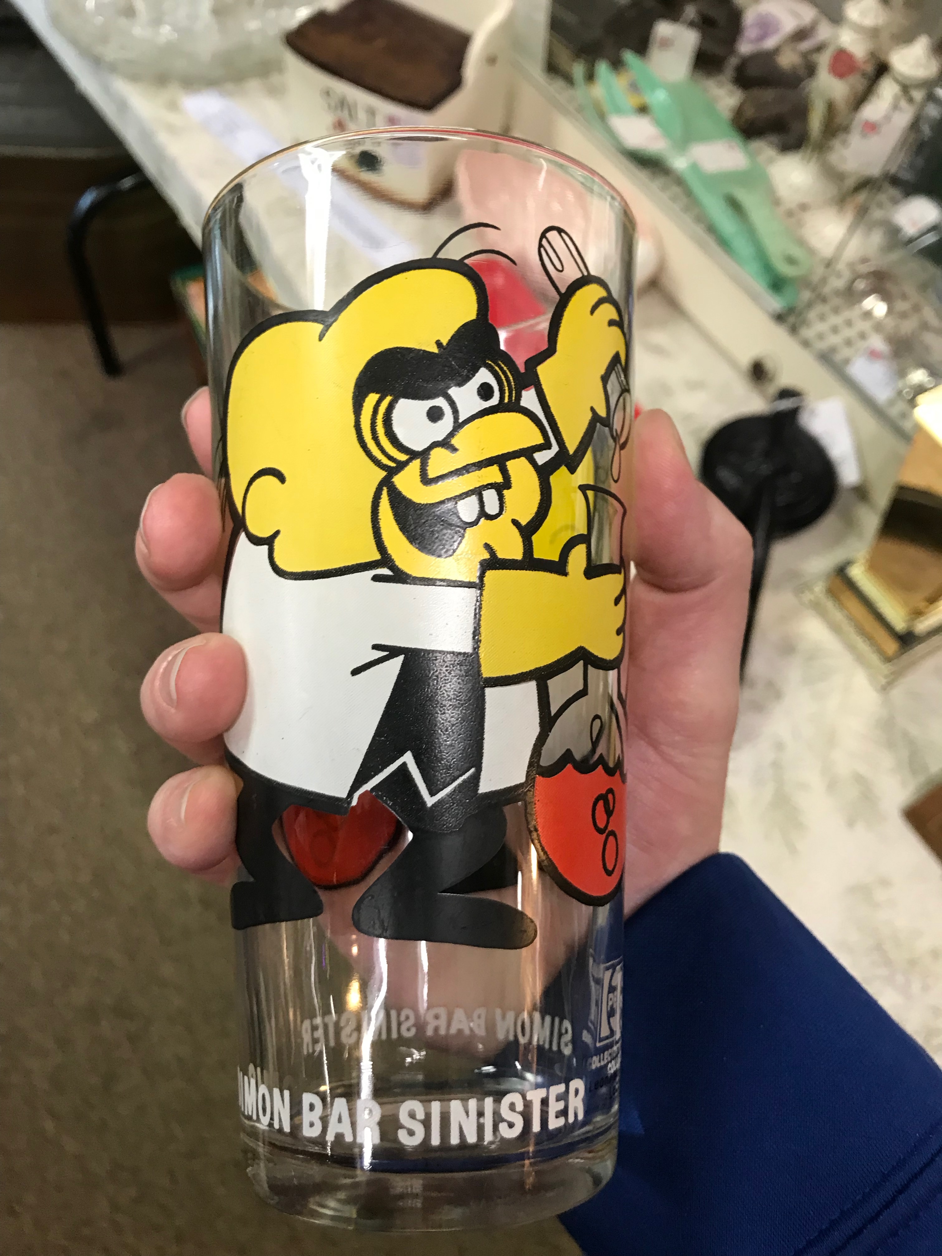 Drinking glass from the 80's with Simon Bar Sinister pictured on it.