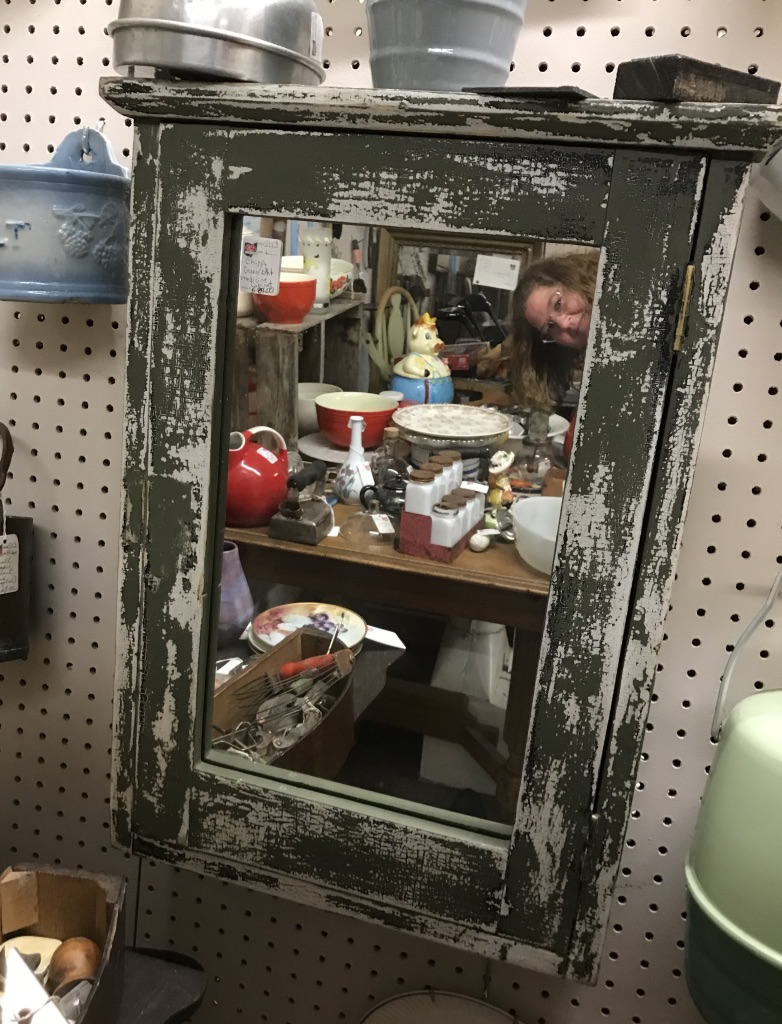 Antique stuff reflecting in a mirror