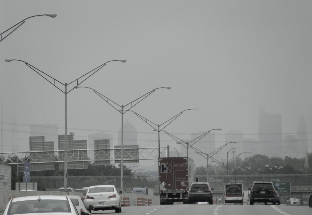 City skyline in foggy rain from highway