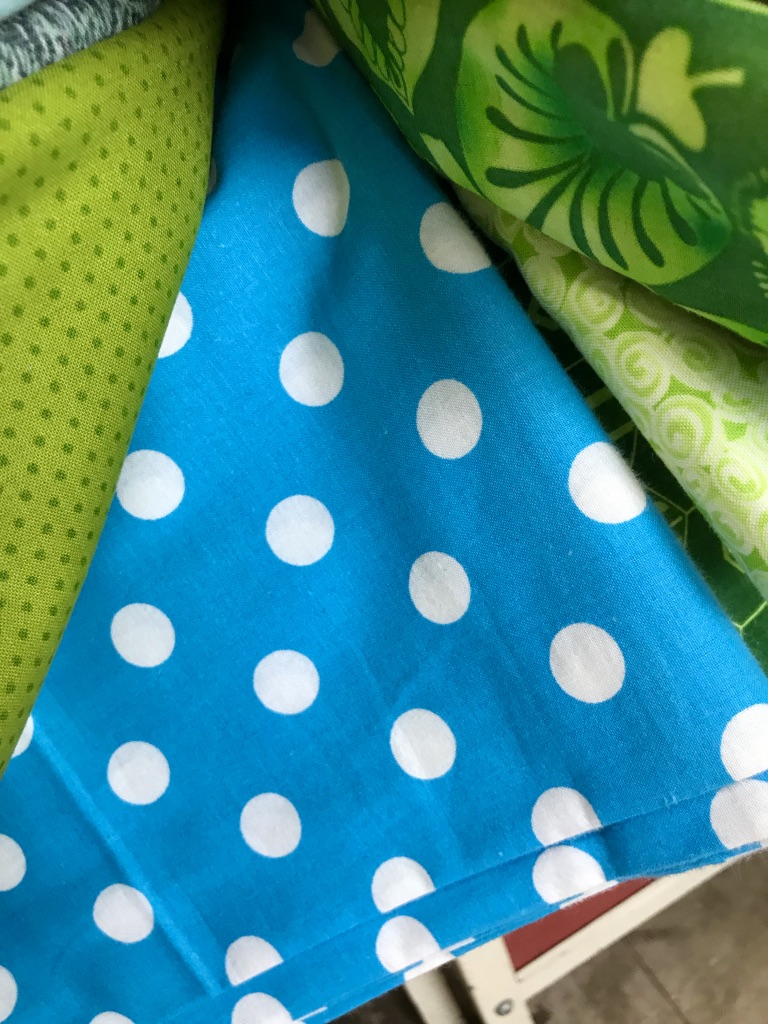 Blue material with white polka dots on it