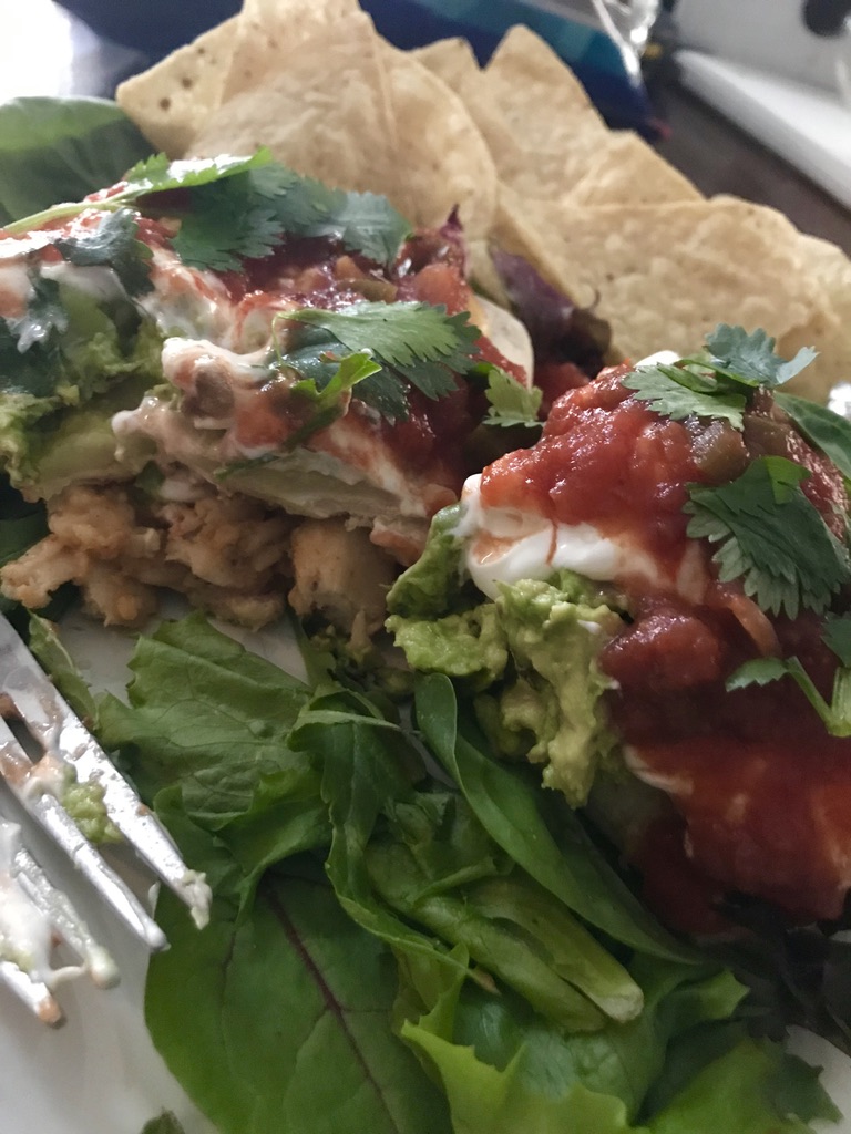 Chicken burrito topped with avocado, salsa, & sourcream