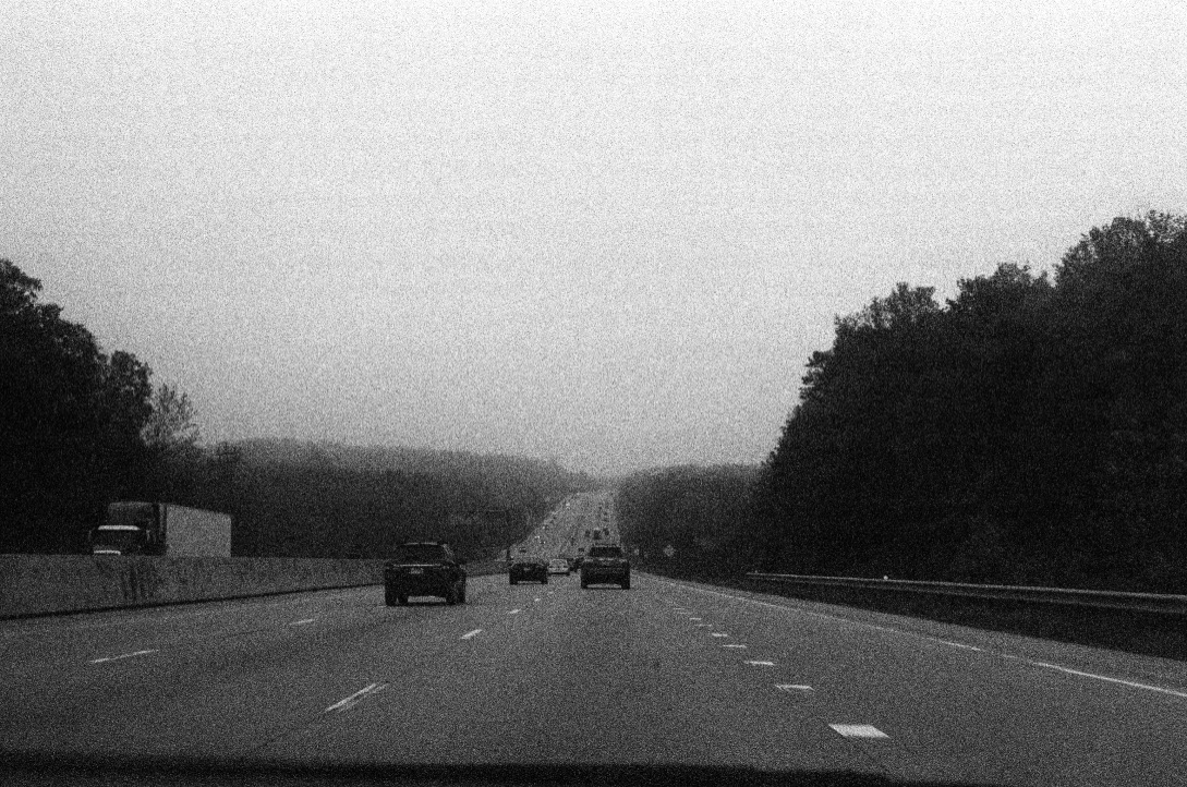 Black and White of a highway from a car