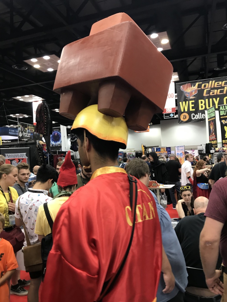 A Man with a giant game piece on his head.