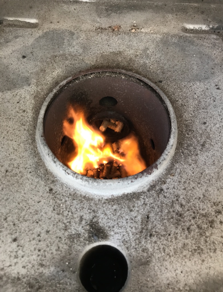 A hole in metal with fire inside