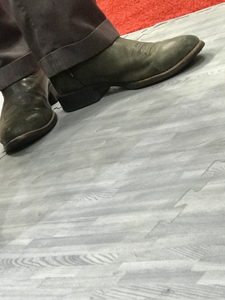 cowboy boots in upper corner and a gray floor