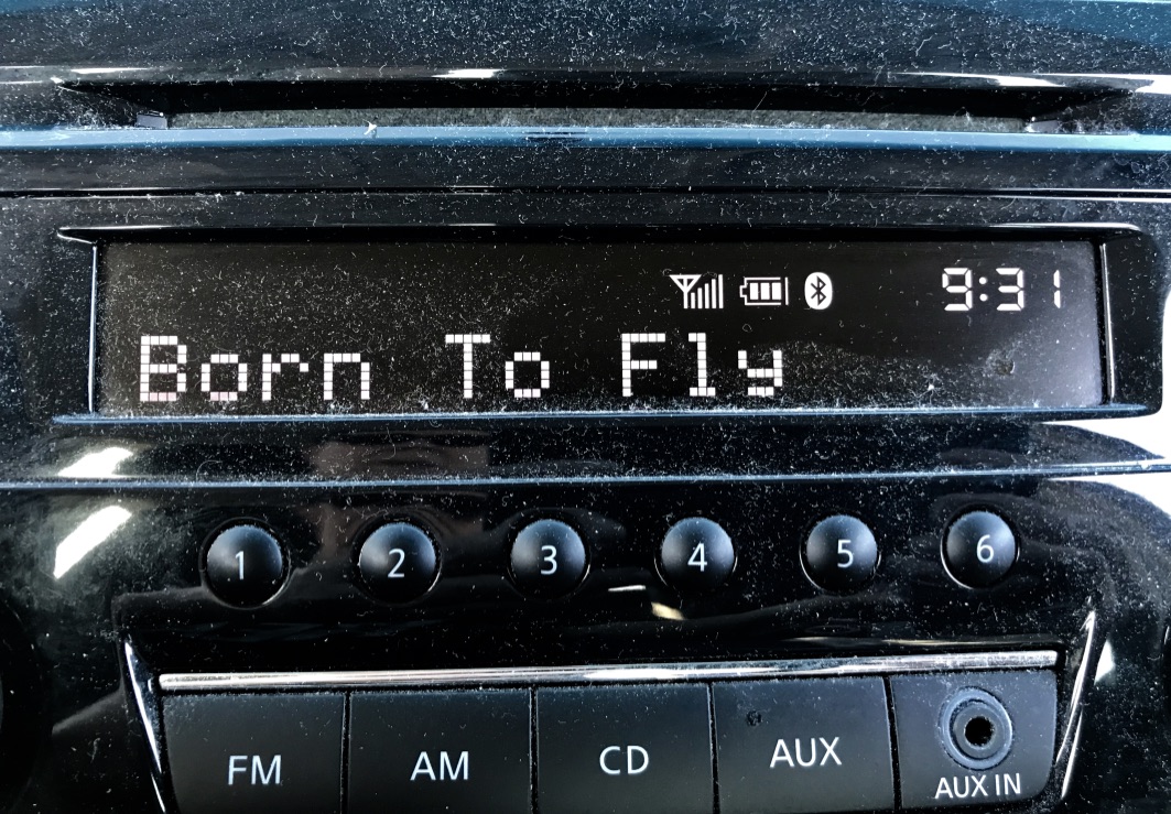 car stereo with song title "Born to fly"  