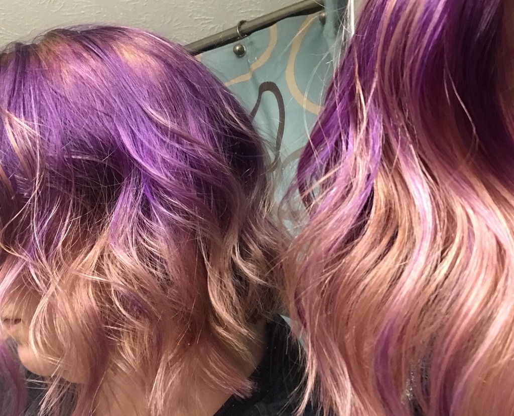 Purple and rose gold colored hair shot in a mirror.