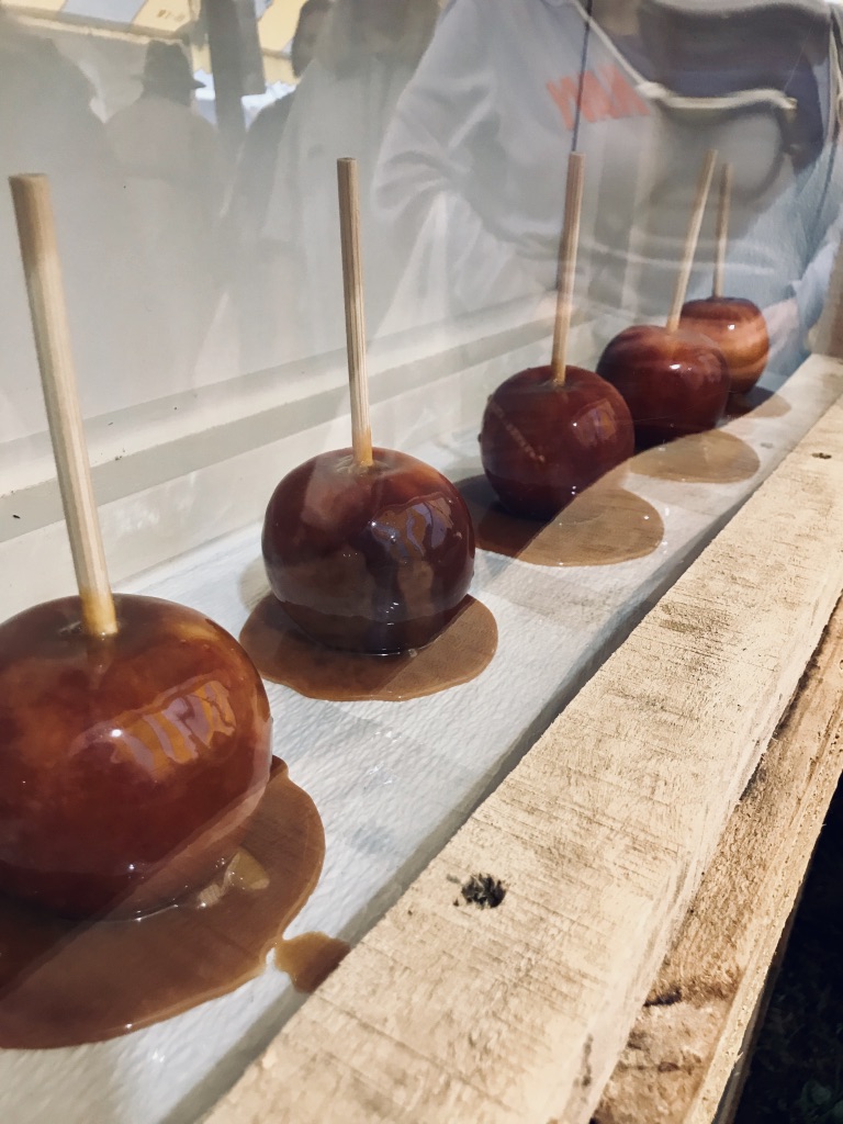 Carmel covered apples behind a glass case.