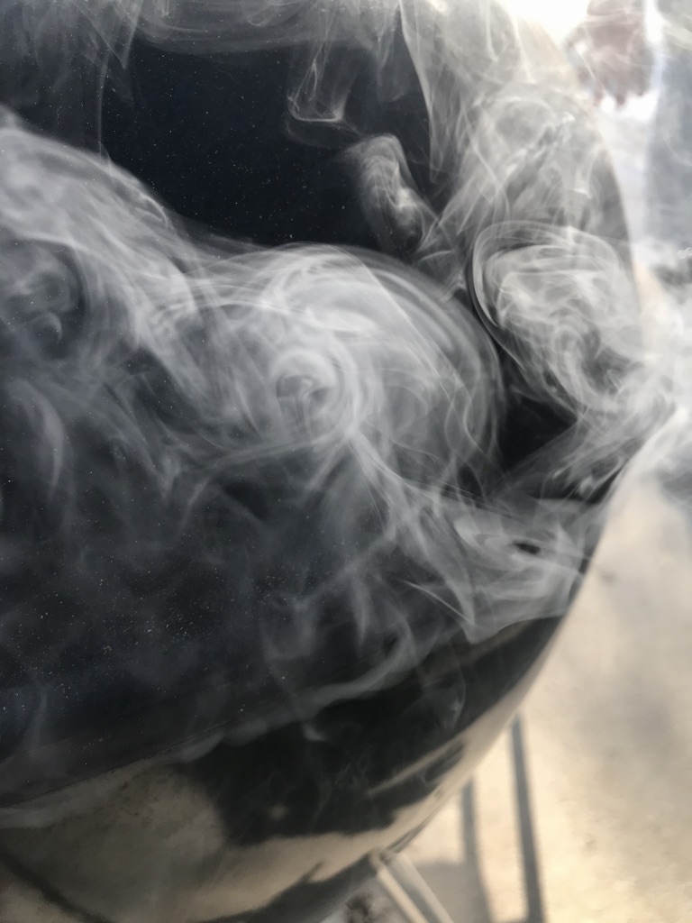 Smoke rolling out of a grill