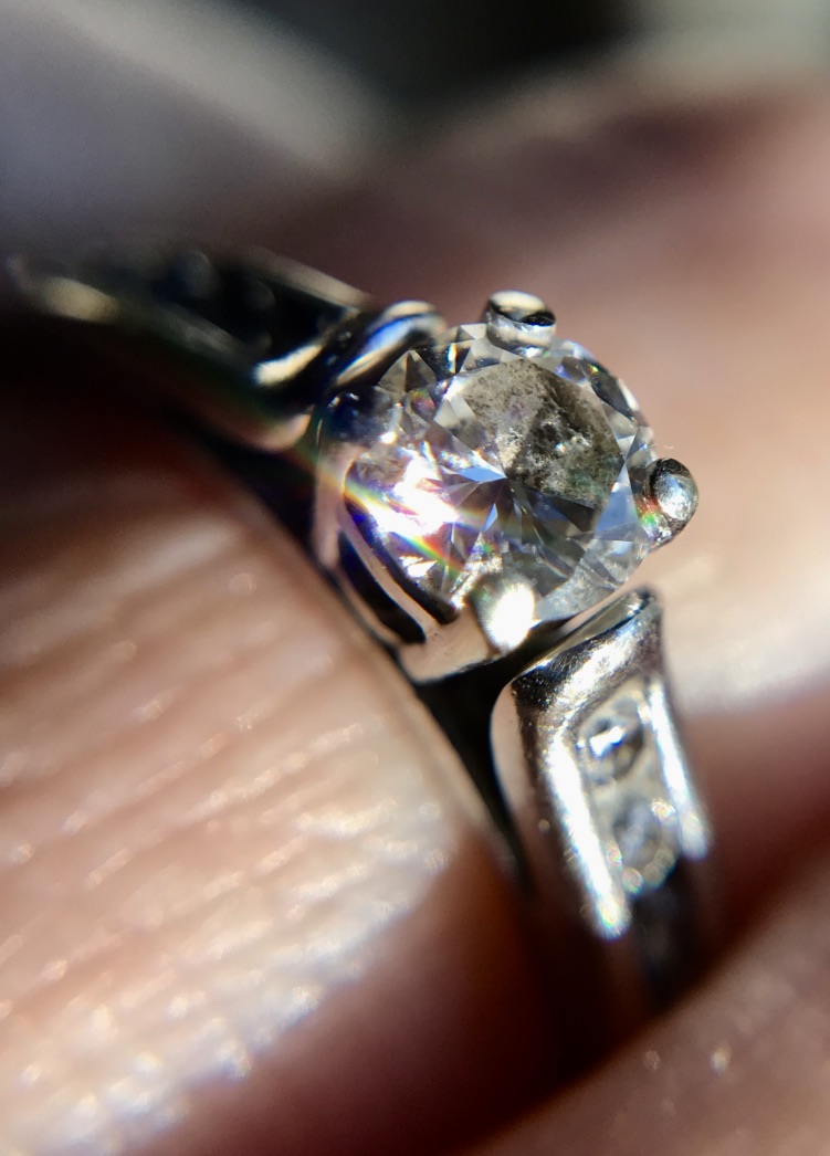 Close up of a diamond ring on a finger
