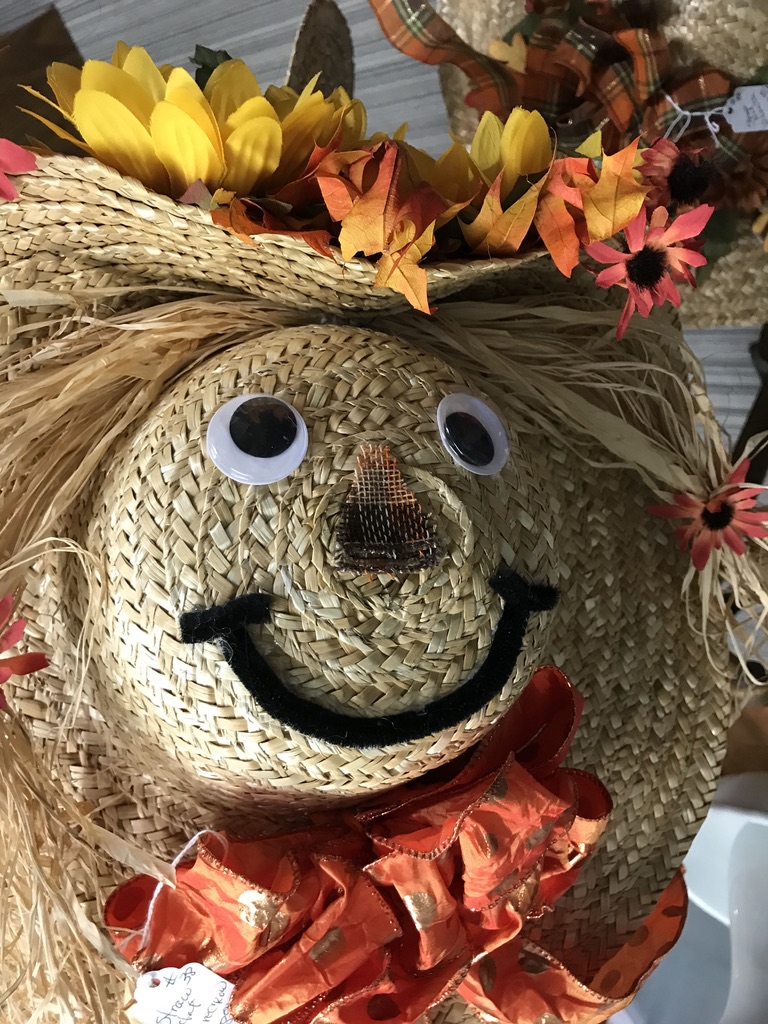A straw hat with a smiley face on the top.